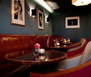 Brown leather chairs and luxury wooden tables interior of Claridge's bar in Mayfair