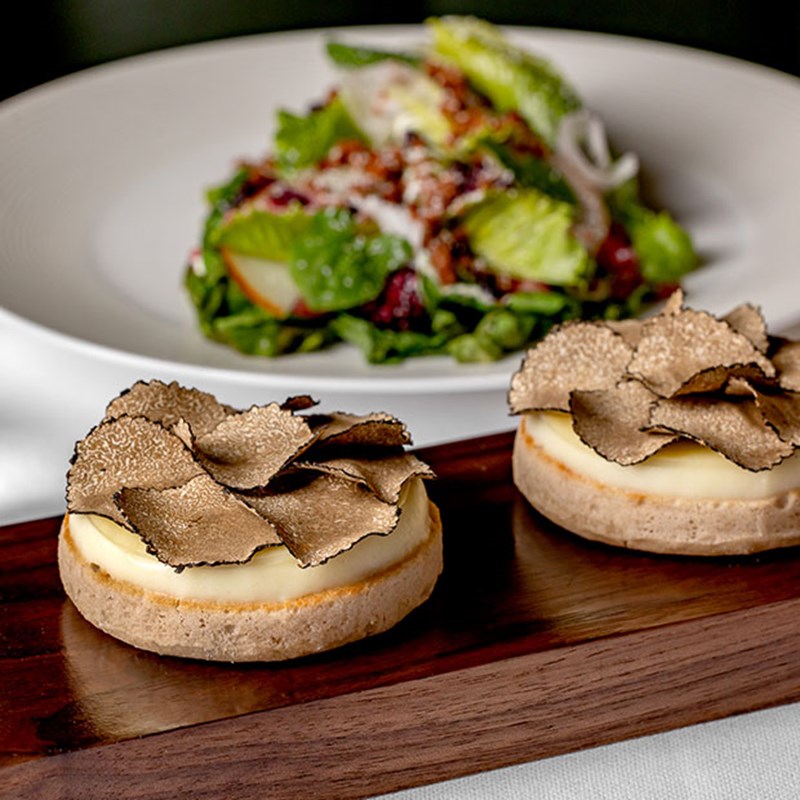 Truffle on crumpets on wooden board