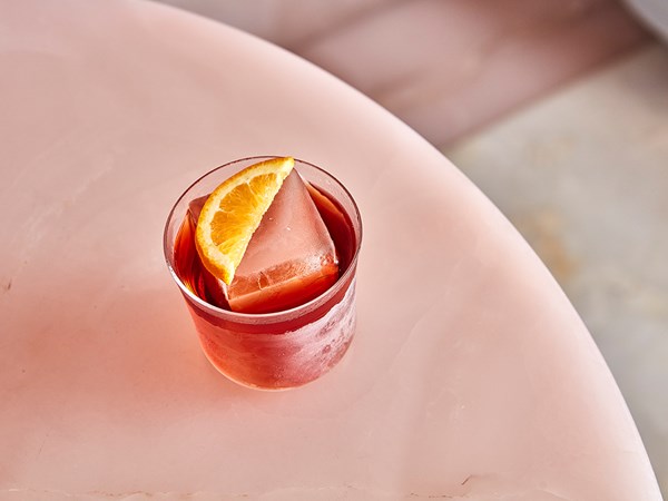 The Painter's Room at Claridge's - cocktail on counter with slice of lemon and ice cube.