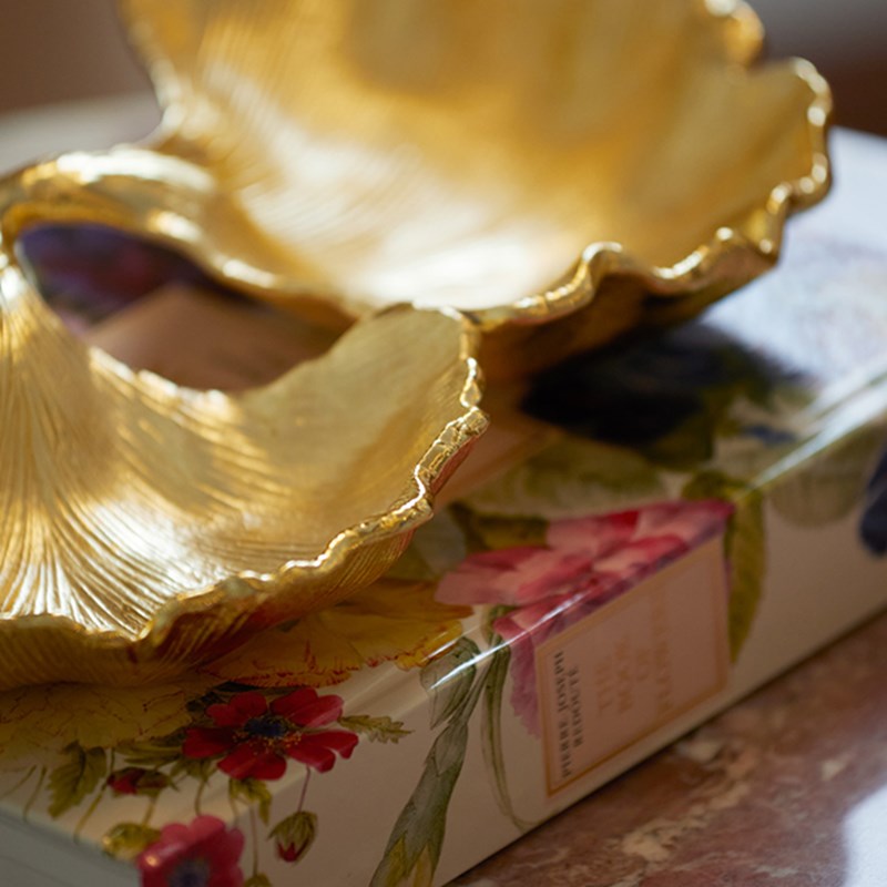 A book with golden artwork on top of it at the Brook Suite at Claridge's