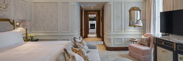 Brook Suite bedroom with bed and TV and the corridor