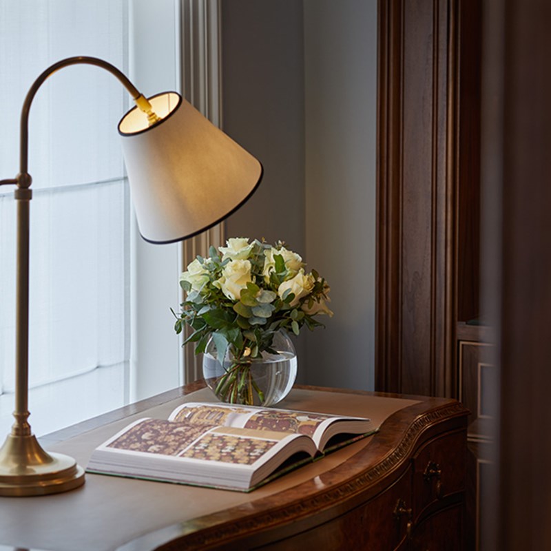 A desk with a book and a light on top at the Brook Suite at Claridge's