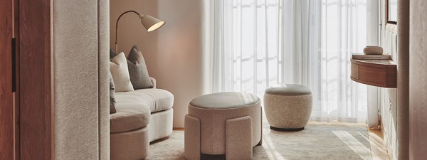 Brown coloured sofas in dressing area of suite