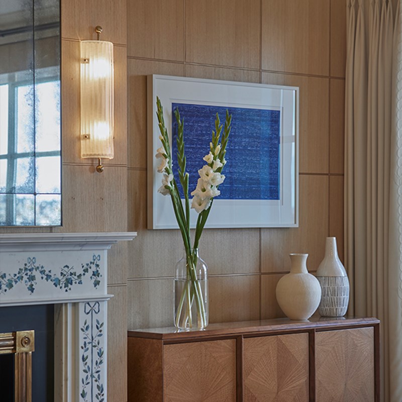 The Mews Pavilion at Claridge's - side table with flowers on it and art on the wall.