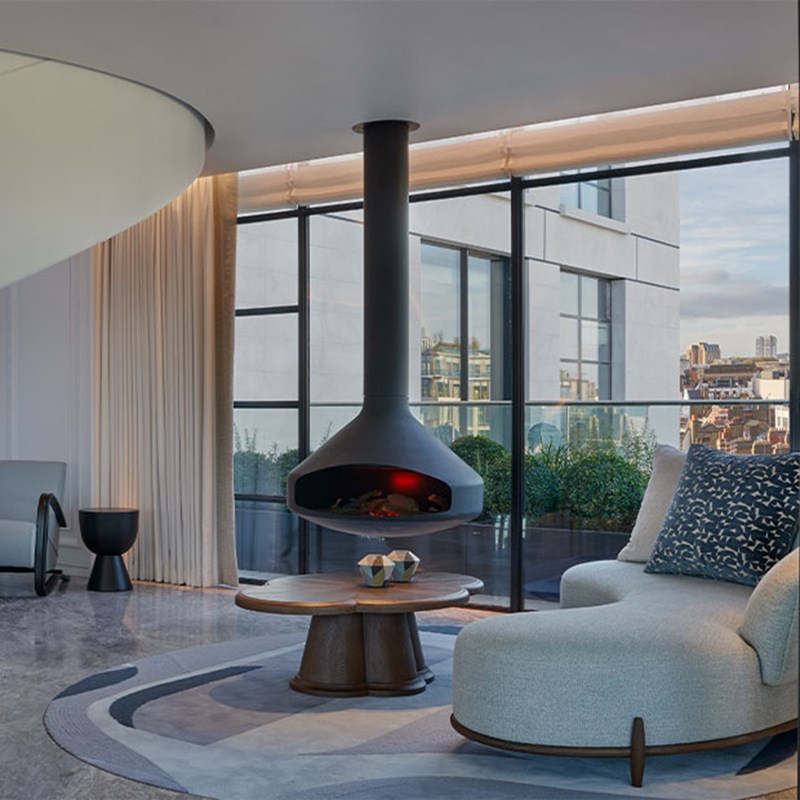 Modern electric fireplace in spacious living room with a lounge chair