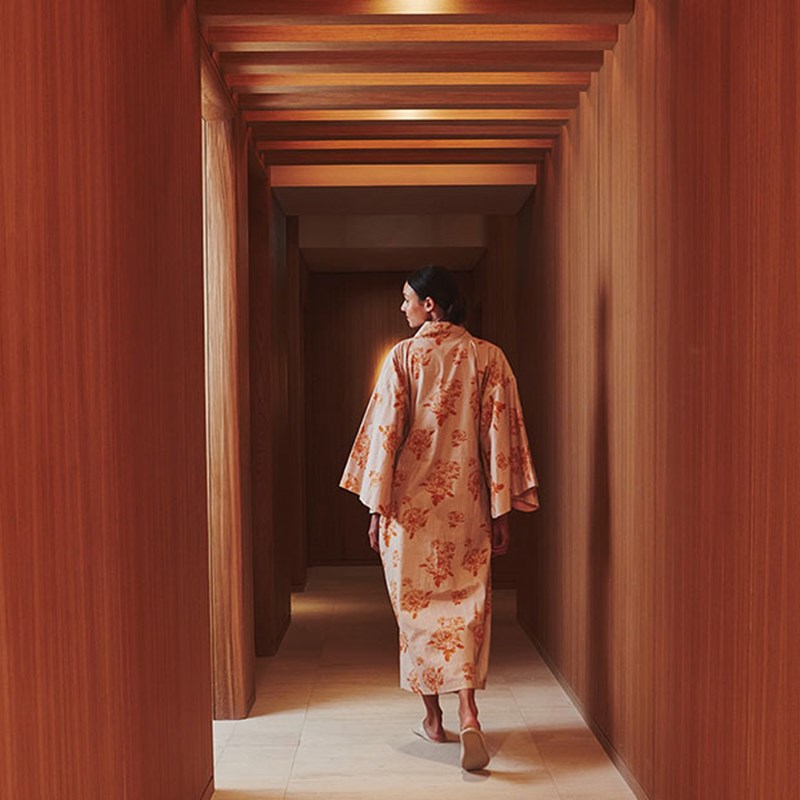 Woman in kimono walking down corridor