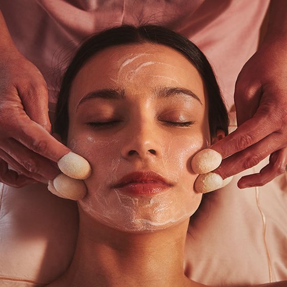 Silk thimble face treatment being performed in woman in the spa