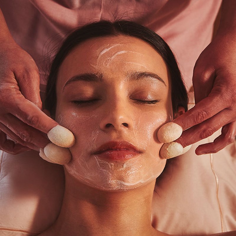 Silk thimble face treatment being performed in woman in the spa